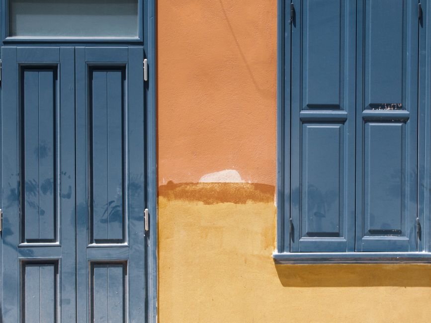 Painted house wall with a window and trim