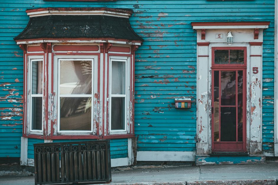 Painted house wall with a window and trim