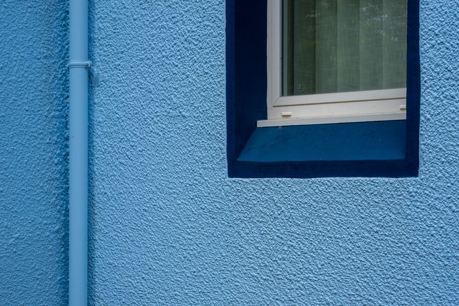 Close view of a painted wall surface and window frame